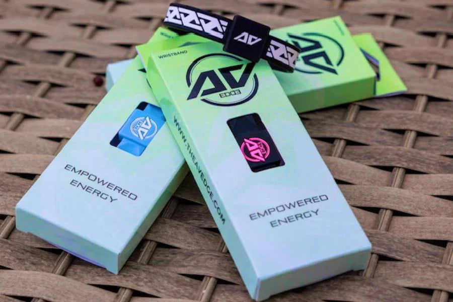 A curated selection of AV Edge Legend and Advanced frequency wristbands in multiple colours, including White/Black, Noir, Cranberry, Black/Pink, and Sky Blue, designed for natural balance and EMF protection.