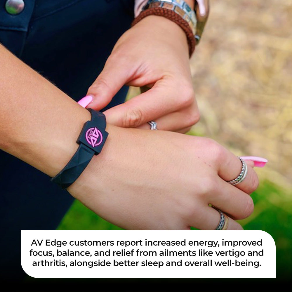 Close-up of the AV Edge Advanced Black/Pink frequency wristband tucked under a red quilted jacket, featuring HEF Technology that might support enhanced cellular energy, focus, and natural EMF protection for active, outdoor lifestyles.
