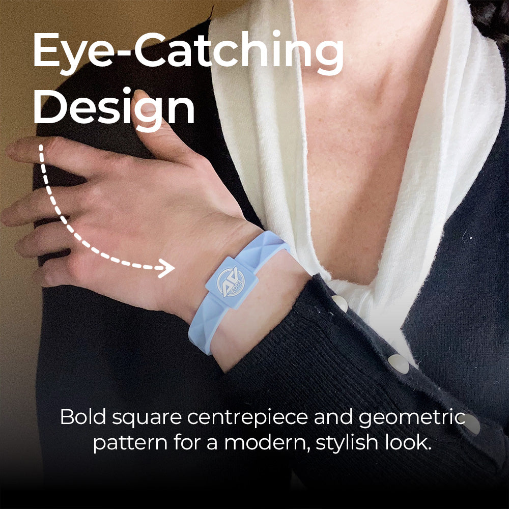 A close-up of a customer wearing the AV Edge Advanced Sky Blue frequency wristband paired with a smart black cardigan, highlighting the modern geometric design that might support improved focus, balance, and natural energy throughout a busy day.